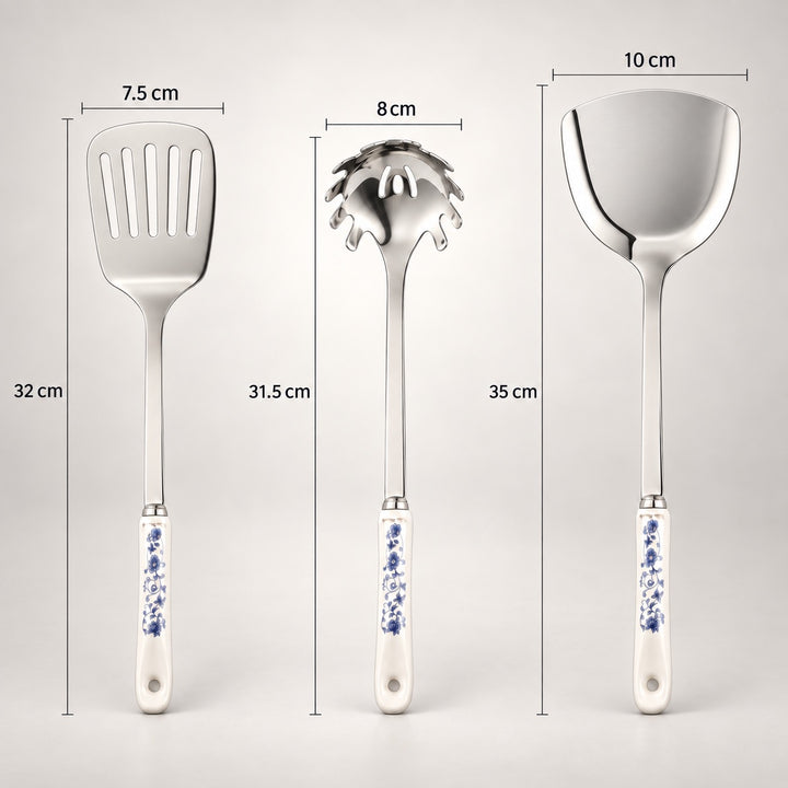 Three stainless steel kitchen utensils with blue-and-white patterned handles are shown on a light grey background with dimension labels: a spatula 7.5 cm wide by 32 cm tall, a spaghetti server 8 cm wide by 31.