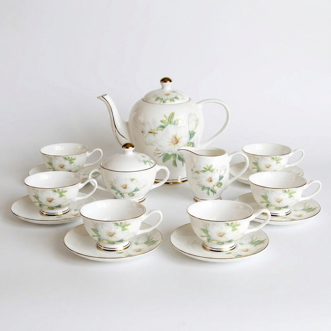 Ivory Camellia fine bone china tea set with white floral pattern and gold detailing on a white background
