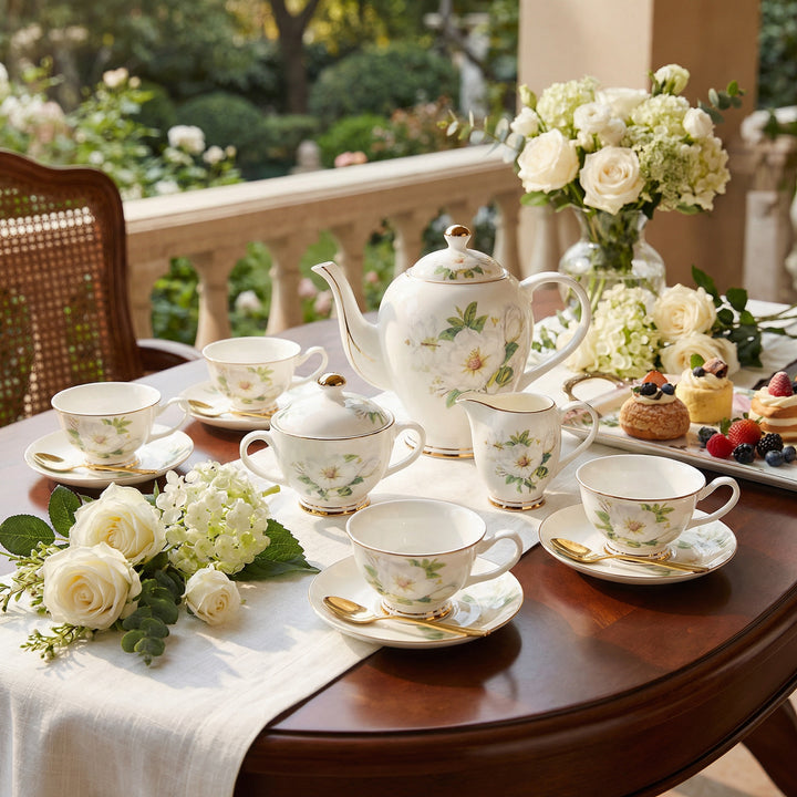 Ivory Camellia fine bone china tea set with floral pattern and gold detailing set on a table outdoors