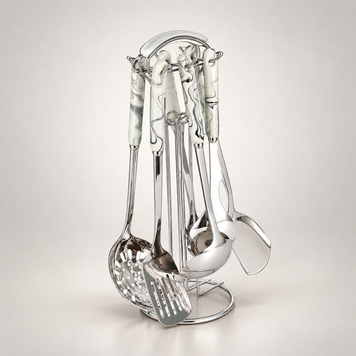 A stainless steel kitchen utensil set with white ceramic handles decorated with grey and black marble patterns, displayed on a matching metal stand against a light grey background.