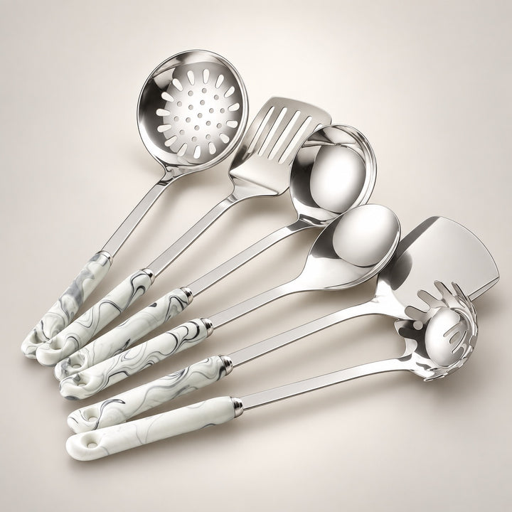 six stainless steel kitchen serving utensils with grey marbled handles, arranged on a light grey background.