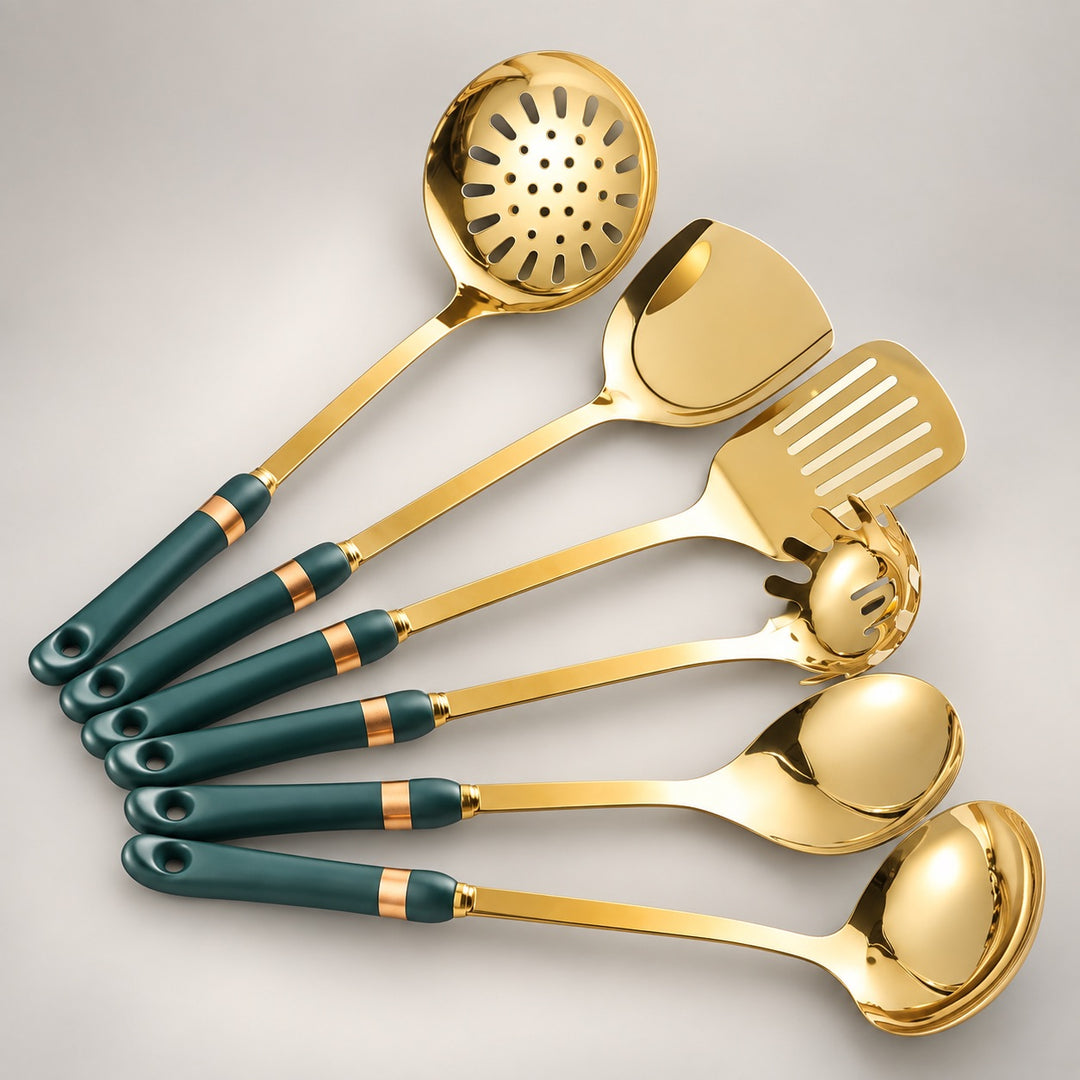 A set of six stainless steel kitchen utensils with dark teal and gold handles, arranged diagonally on a light gray background. The utensils include a slotted ladle, a spatula, a turner, and four spoons.