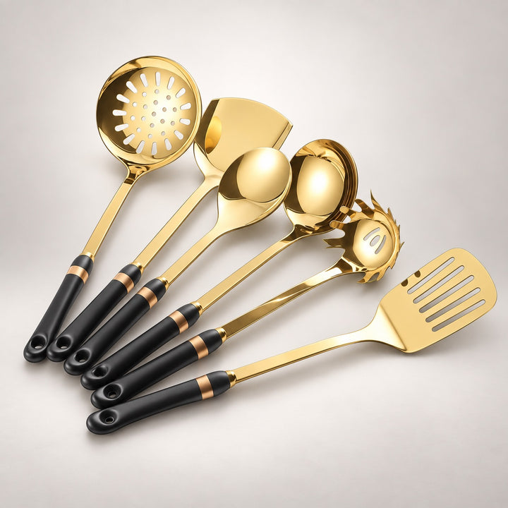A set of six gold-colored kitchen utensils with black and gold handles, including a slotted spoon, spatulas, and ladles, arranged on a light gray background.