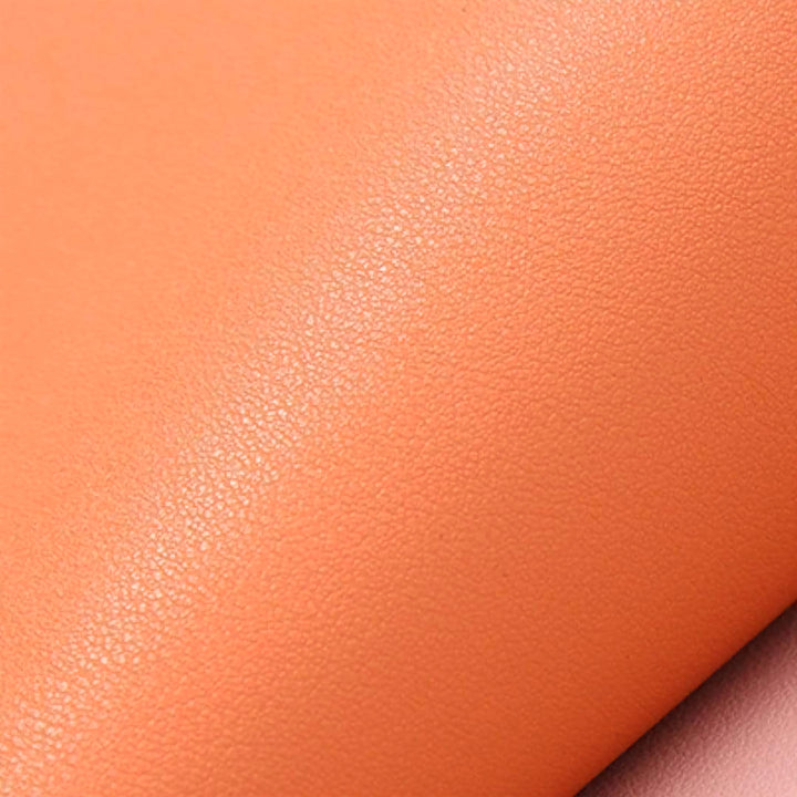 Close-up of the texture of the SophistiMat orange leather placemat.