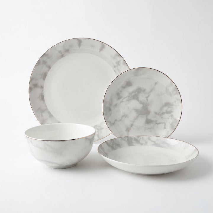 Aurelia 16-piece fine bone china dinner set with marble design and hand-painted gold edge