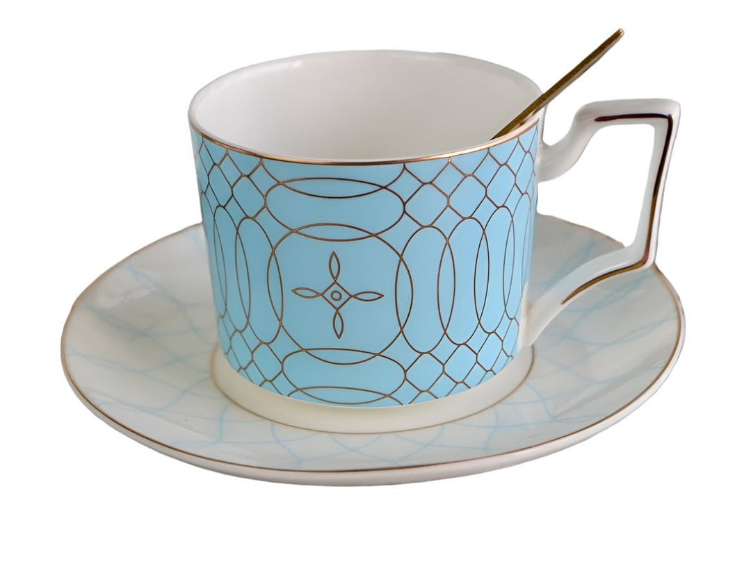 Light blue and white teacup with saucer and gold spoon, part of a bone china tea set.