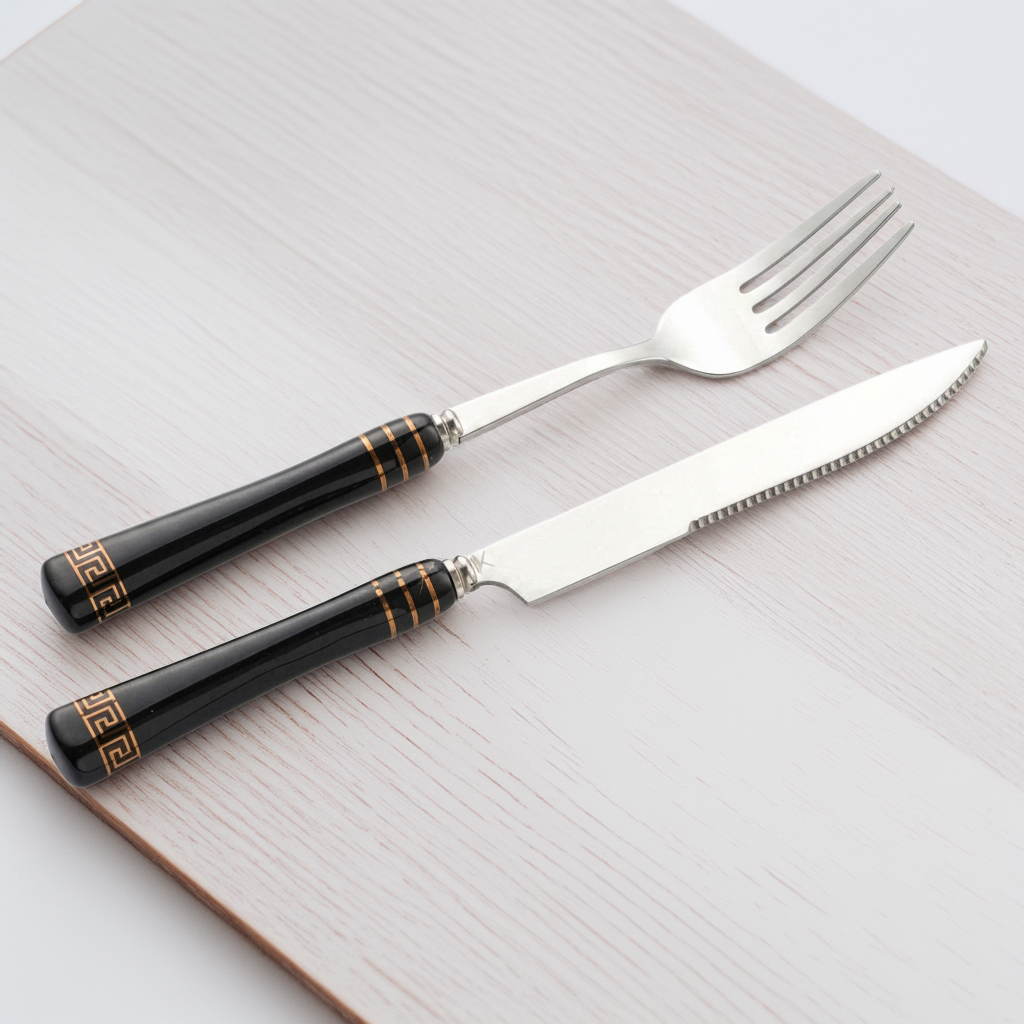 Heritage Gold table fork and knife with black ceramic handles and gold detailing
