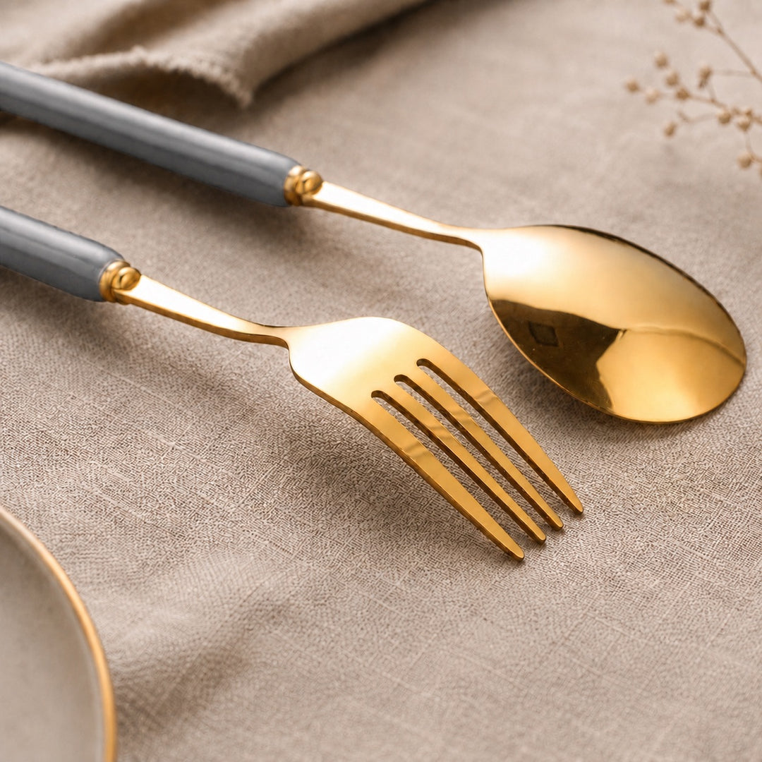 Close-up of Marlowe gold fork and soup spoon with Pearl Grey handles