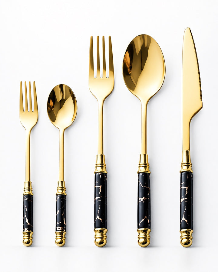 Five-piece flatware set with gold-tone polished handles and black marble-patterned grips, arranged by size on a clean white background.